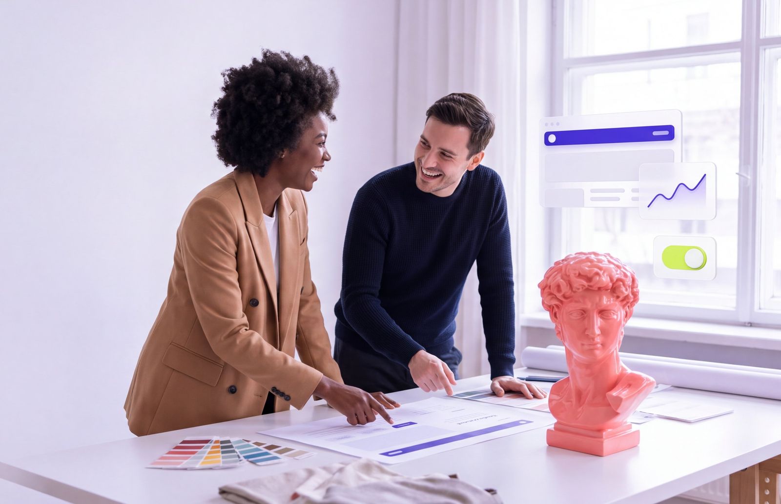 Two designers planning a website together at a studio table
